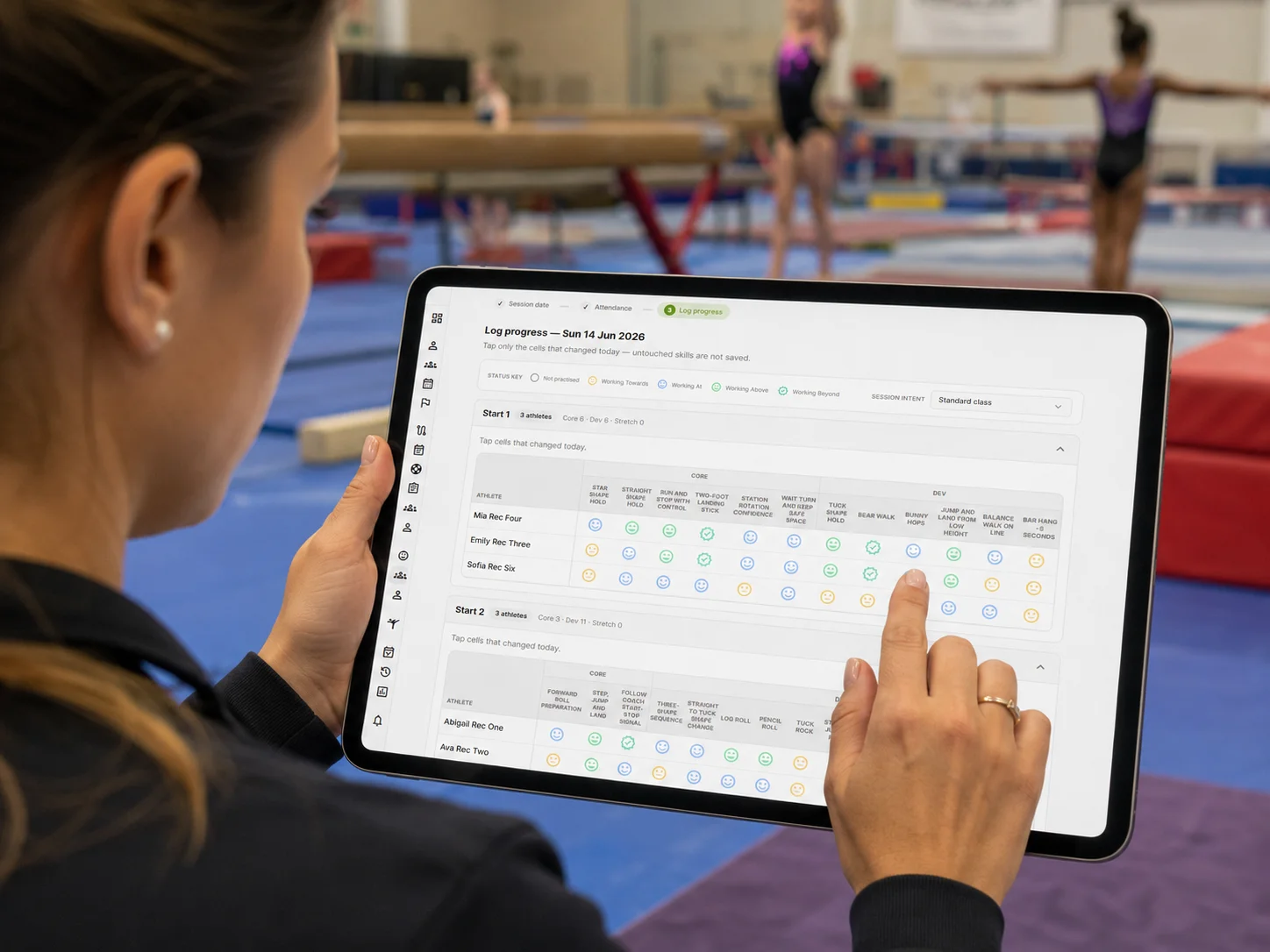 Coach using The Gymnast Portal session logging workflow on a tablet